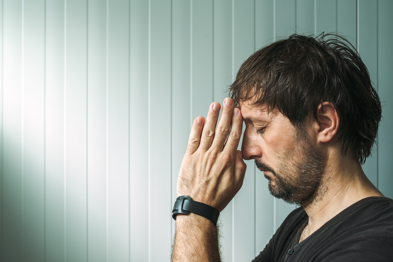 Profile portrait of Christian man praying with copy space faith and religion concept.