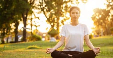 Mulher branca meditando.